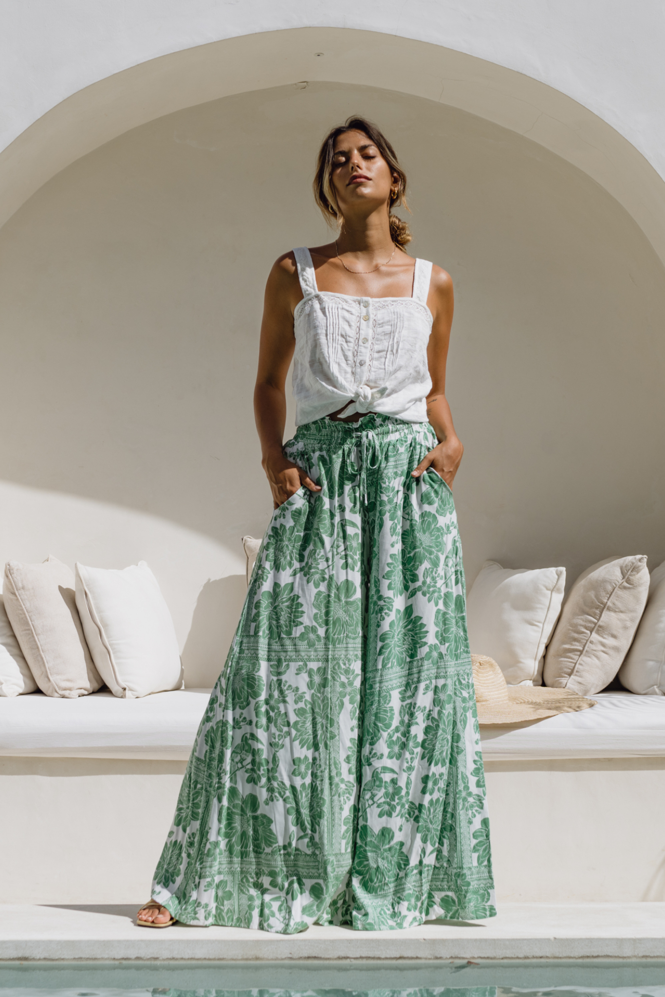 model wearing a pair of green floral pants